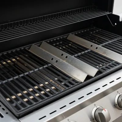 Close-up of Nexgrill 4-burner gas grill components, highlighting flame tamers and grates.